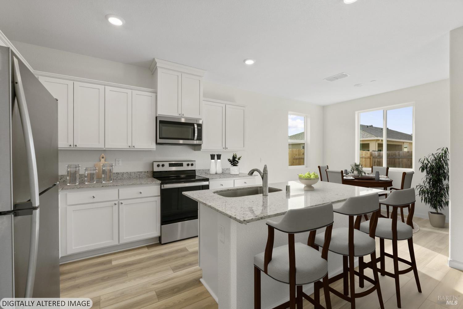 2261 Espana Lane Rio Vista, CA 94571 - Photo 9 of 20 a kitchen with granite countertop white cabinets and stainless steel appliances