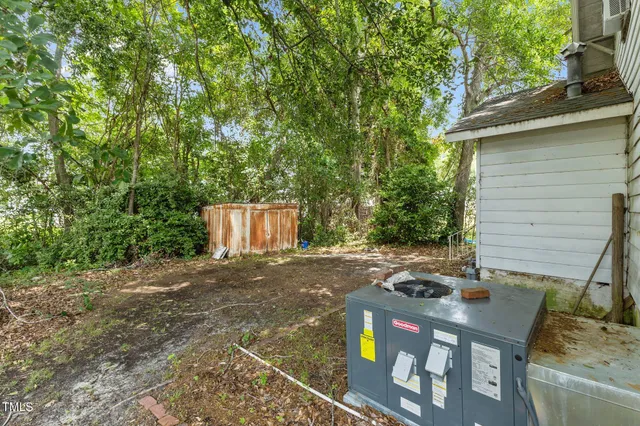 a view of a patio with table and chairs with wooden fence and plants