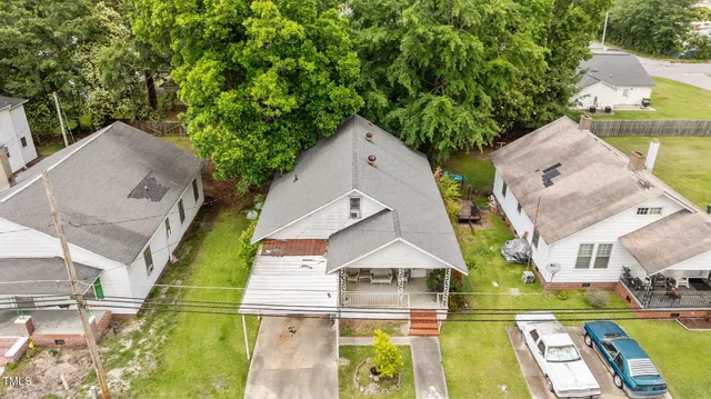 aerial view of a house with large trees