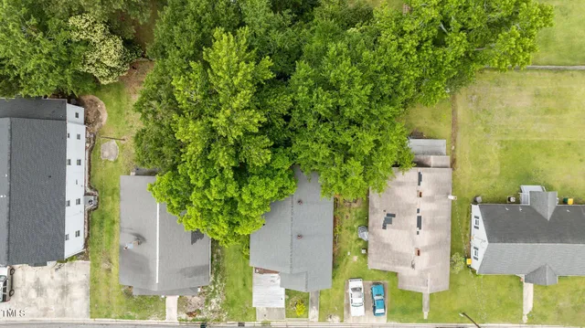 an aerial view of residential houses with outdoor space and river view