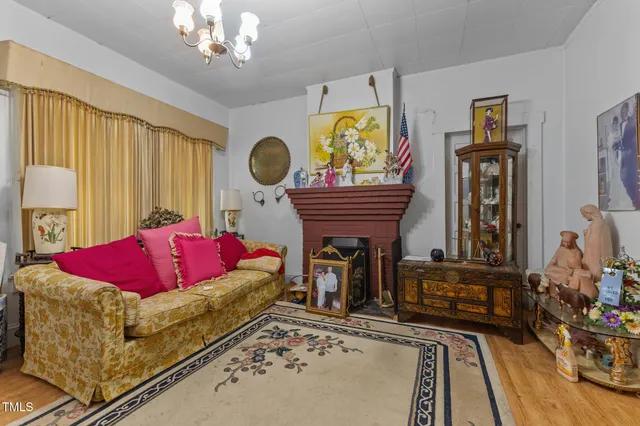 a living room with fireplace furniture and a chandelier
