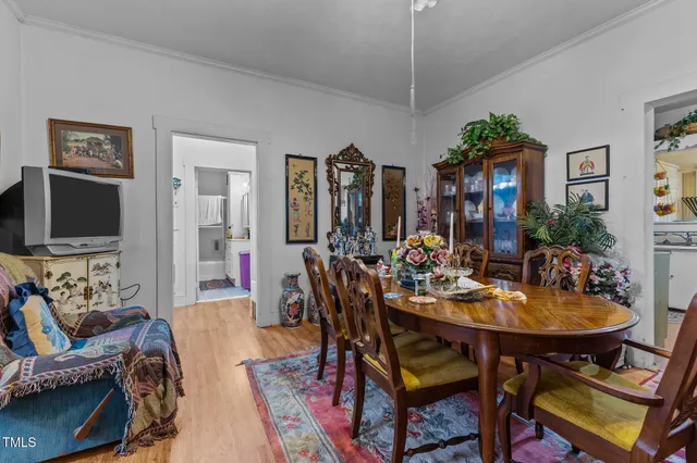 a view of a dining room with furniture and chandelier
