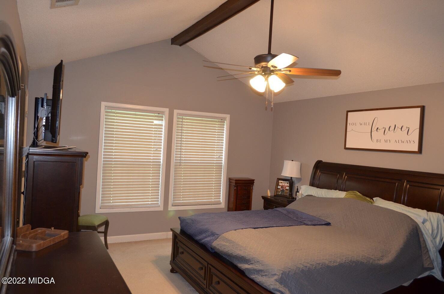 5760 Sardis Church Road Macon, GA 31216 - Photo 11 of 21 a bedroom with a bed and a chandelier