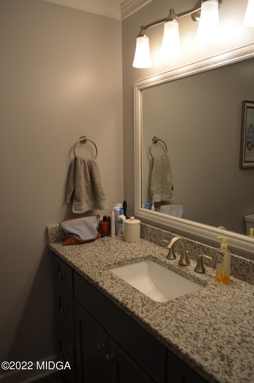 5760 Sardis Church Road Macon, GA 31216 - Photo 12 of 21 a bathroom with a granite countertop sink and a mirror