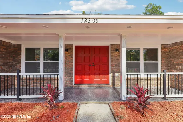 a bedroom with a large bed and a large window