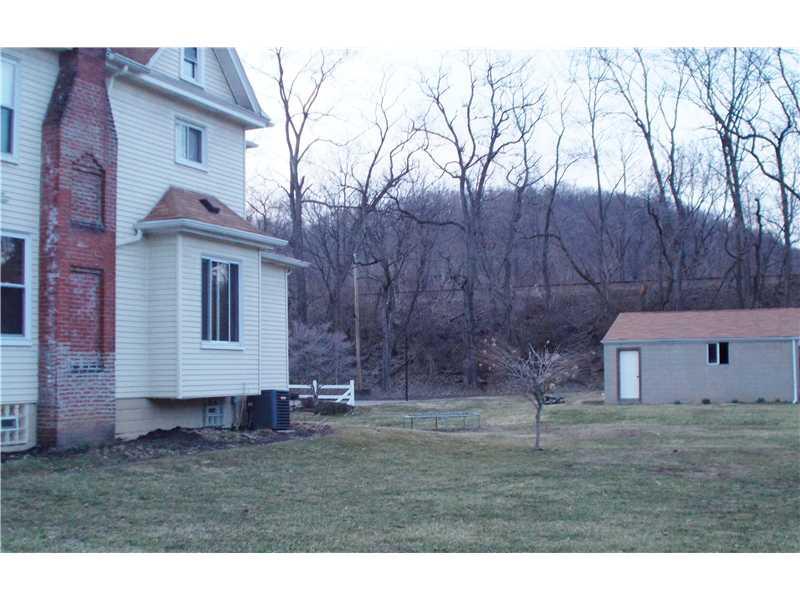 15 Riverside Drive Freeport, PA 16229 - Photo 24 of 25 Facade/Exterior Front. Side view of the home, Flat double lot & 2 car detached garage. Bring the kids and get that backyard baseball game going.