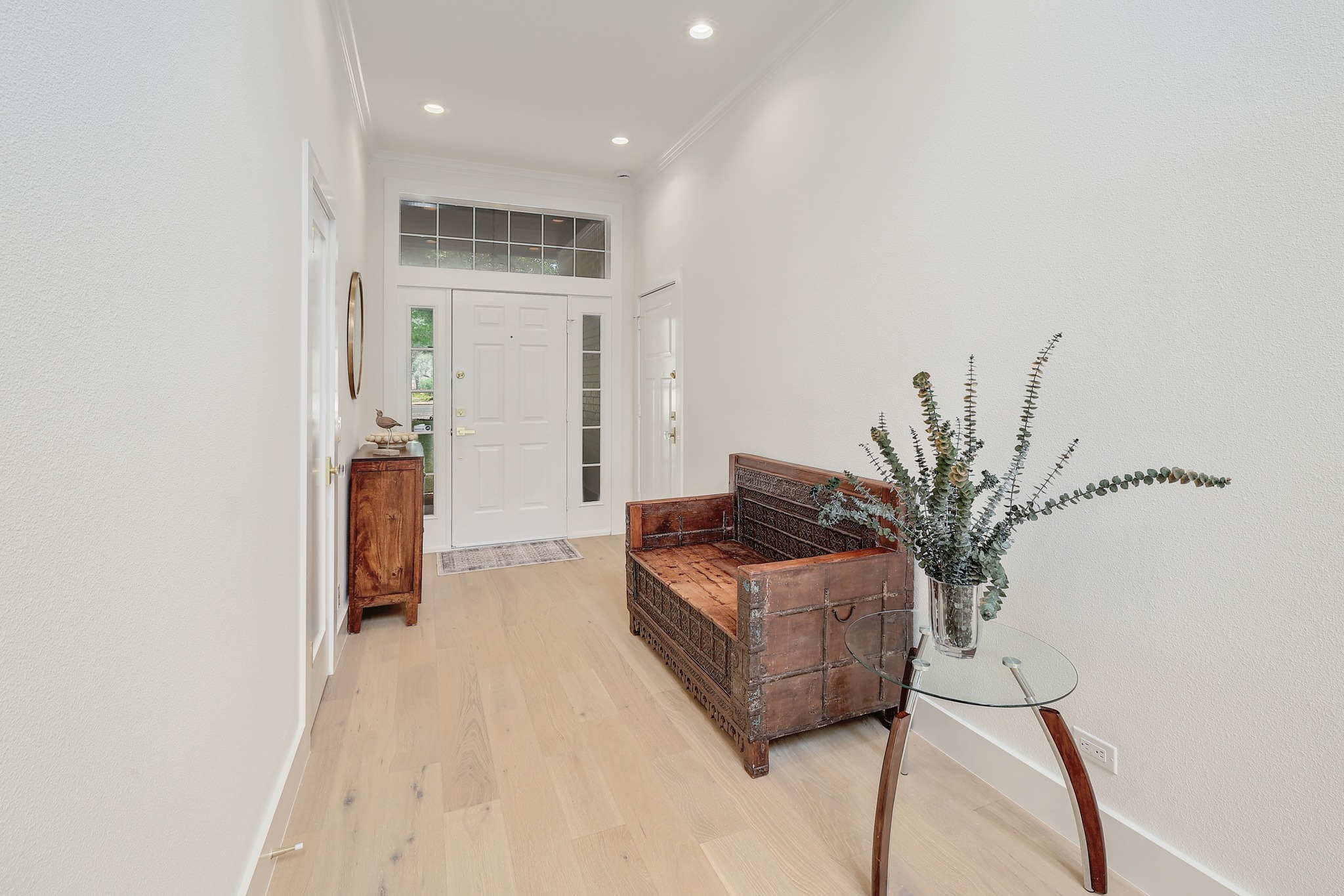 7705 Jester Boulevard Austin, TX 78730 - Photo 2 of 36 A well-lit entry hall with warm hardwood floors welcomes guests.
