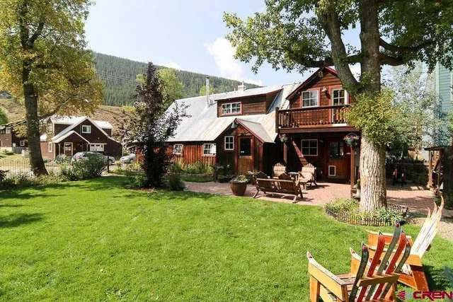 a front view of a house with sitting area and furniture