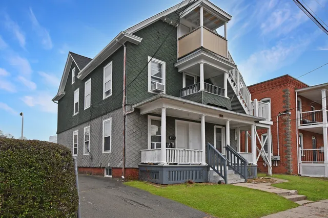 a front view of a house with a yard