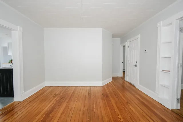a view of a room with wooden floor