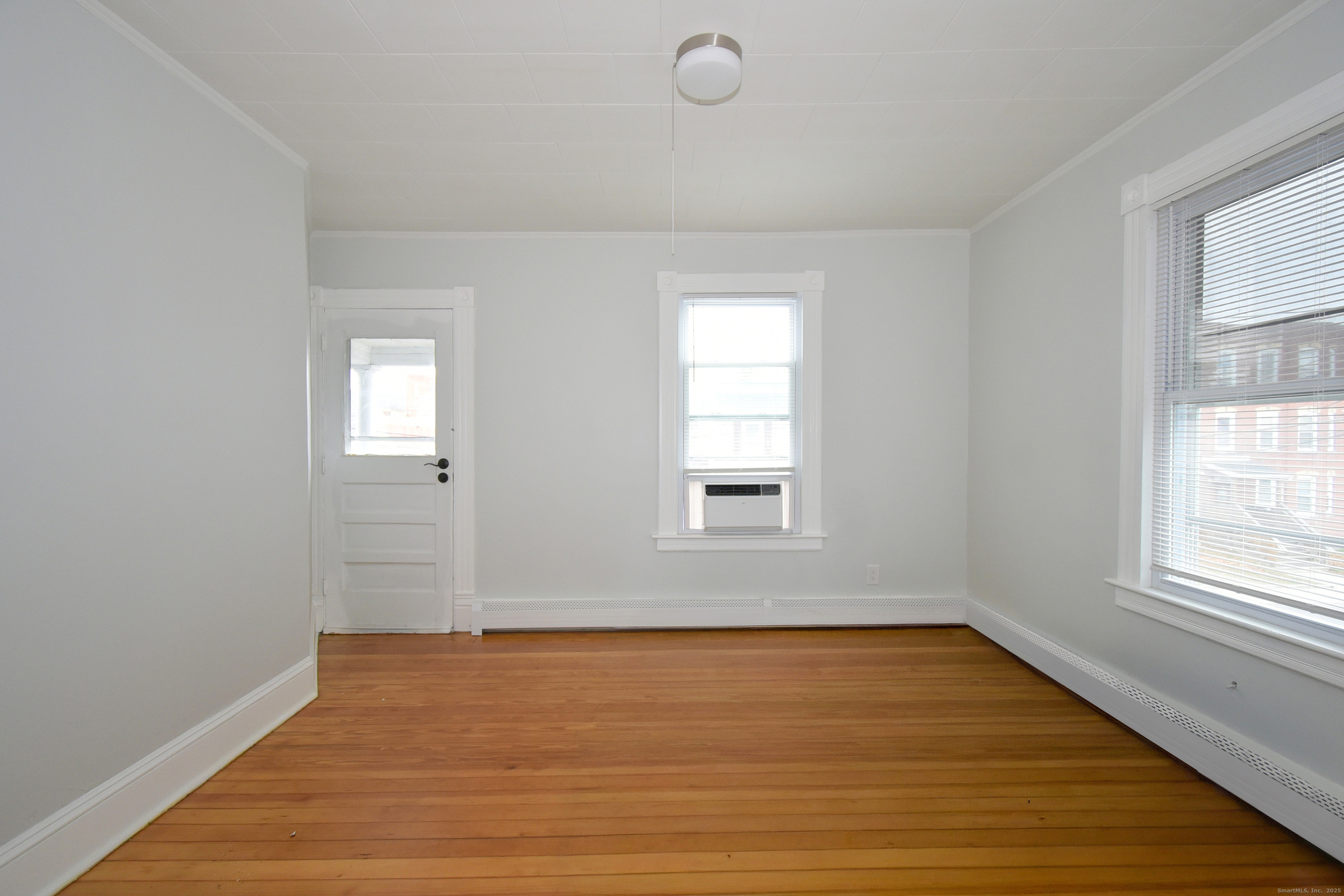 22 Kelley Street Bristol, CT 06010 - Photo 14 of 19 an empty room with wooden floor and windows