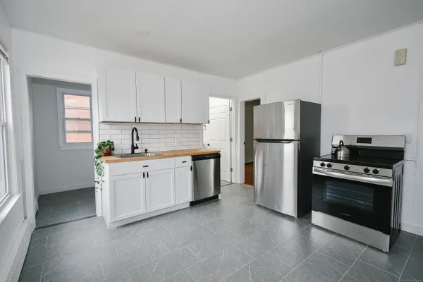 a kitchen with a refrigerator sink and stove