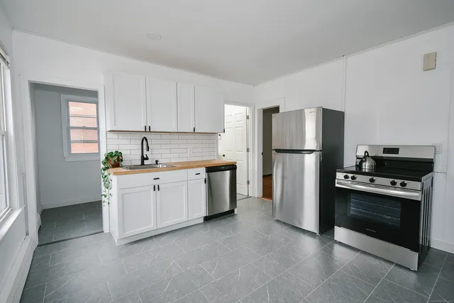 a kitchen with a refrigerator sink and stove