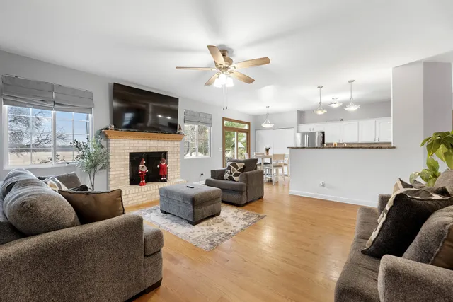 a living room with furniture a flat screen tv and a fireplace