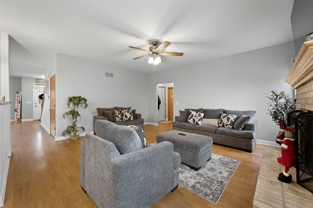 a living room with furniture and wooden floor