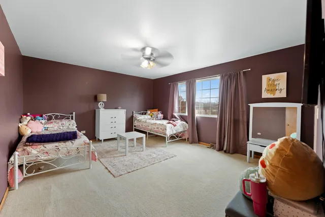 a bed room with a bed and a chair