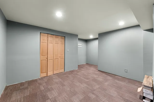 a view of an empty room and wooden floor
