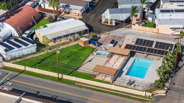 an aerial view of residential houses with outdoor space