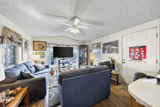 a bedroom with a bed and a flat tv screen on the dresser