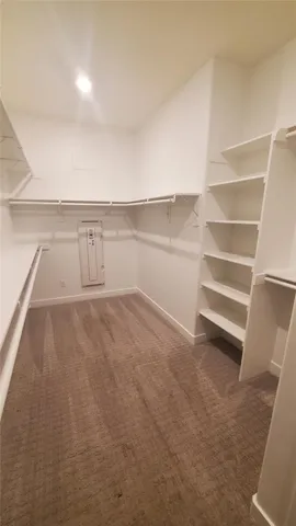 a view of walk in closet with empty racks