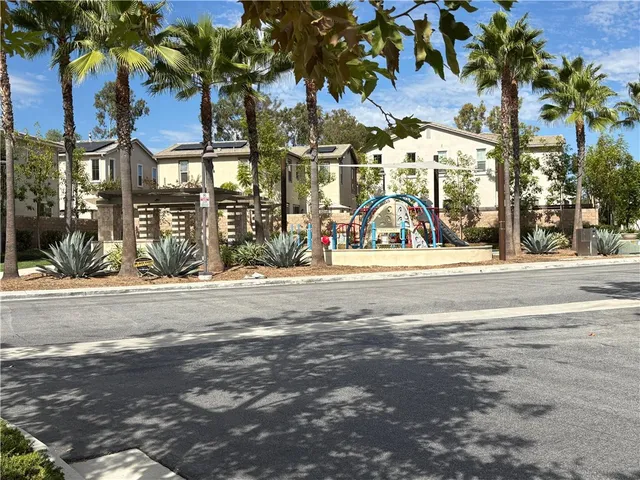 a view of road with a building and trees in the background
