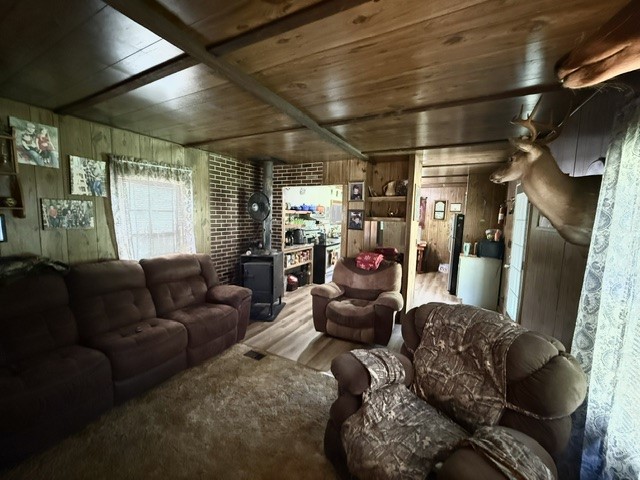 731 Glenn Ferry Road Fair Play, SC 29643 - Photo 7 of 23 A cozy retreat featuring wood-paneled walls and a classic wood-burning fireplace, perfect for intimate gatherings.