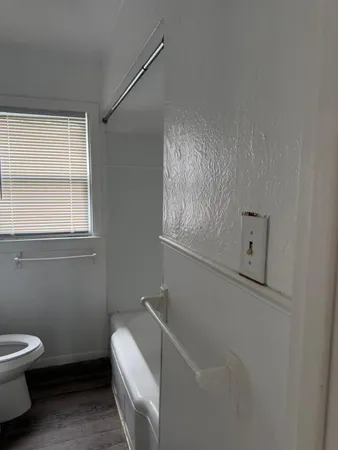 a bathroom with a toilet sink and tub
