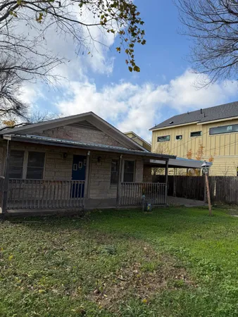 a view of a house with a backyard porch and sitting area