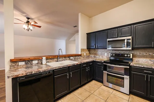 a kitchen with a sink stove and microwave