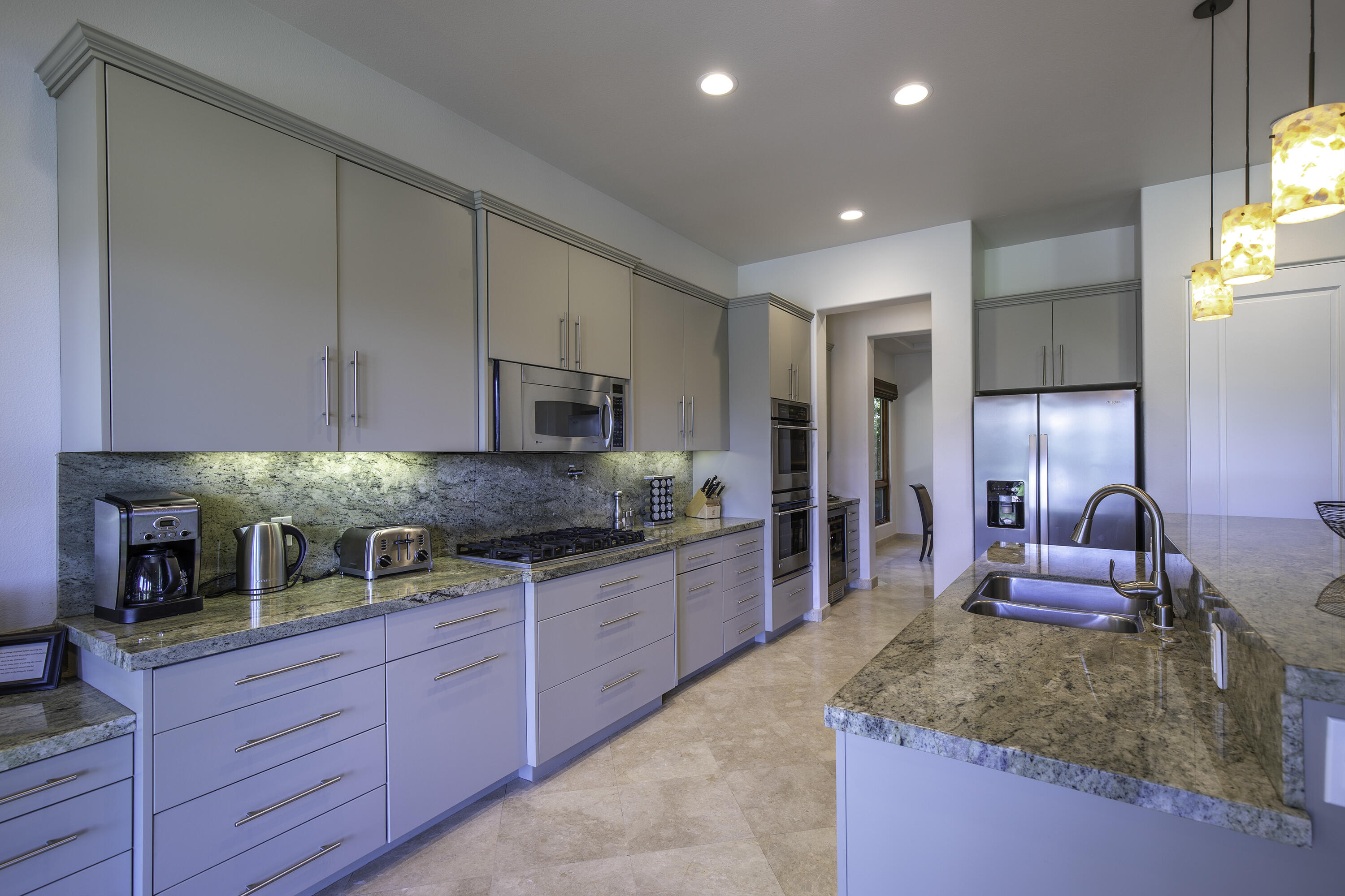 72737 Verbenia Road Rancho Mirage, CA 92270 - Photo 8 of 29 a large kitchen with stainless steel appliances granite countertop a lot of counter space and a sink
