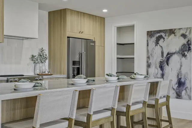 a dining table with chairs and cabinets