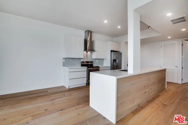 a kitchen with kitchen island sink and stove