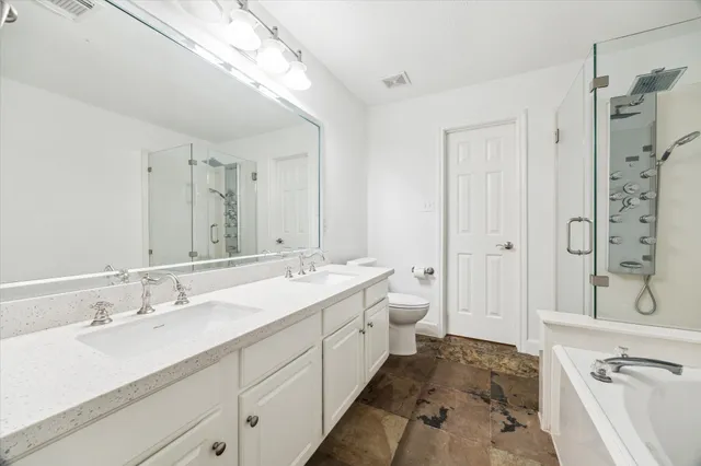 a bathroom with a bathtub and shower