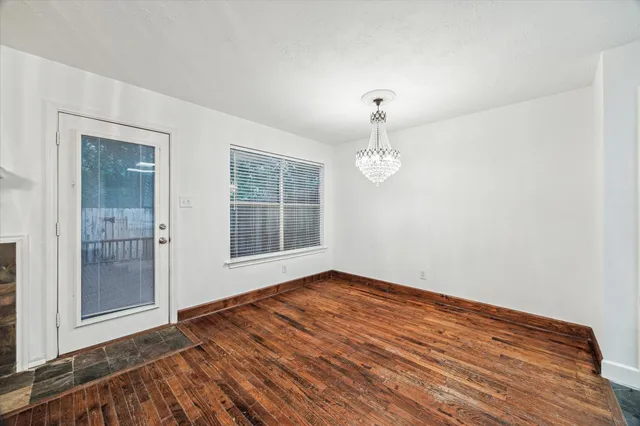 a view of a room with wooden floor and white walls
