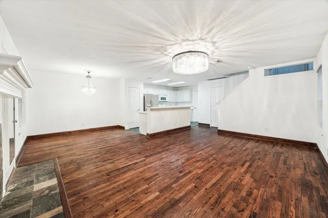 a view of a kitchen with wooden floor and a sink