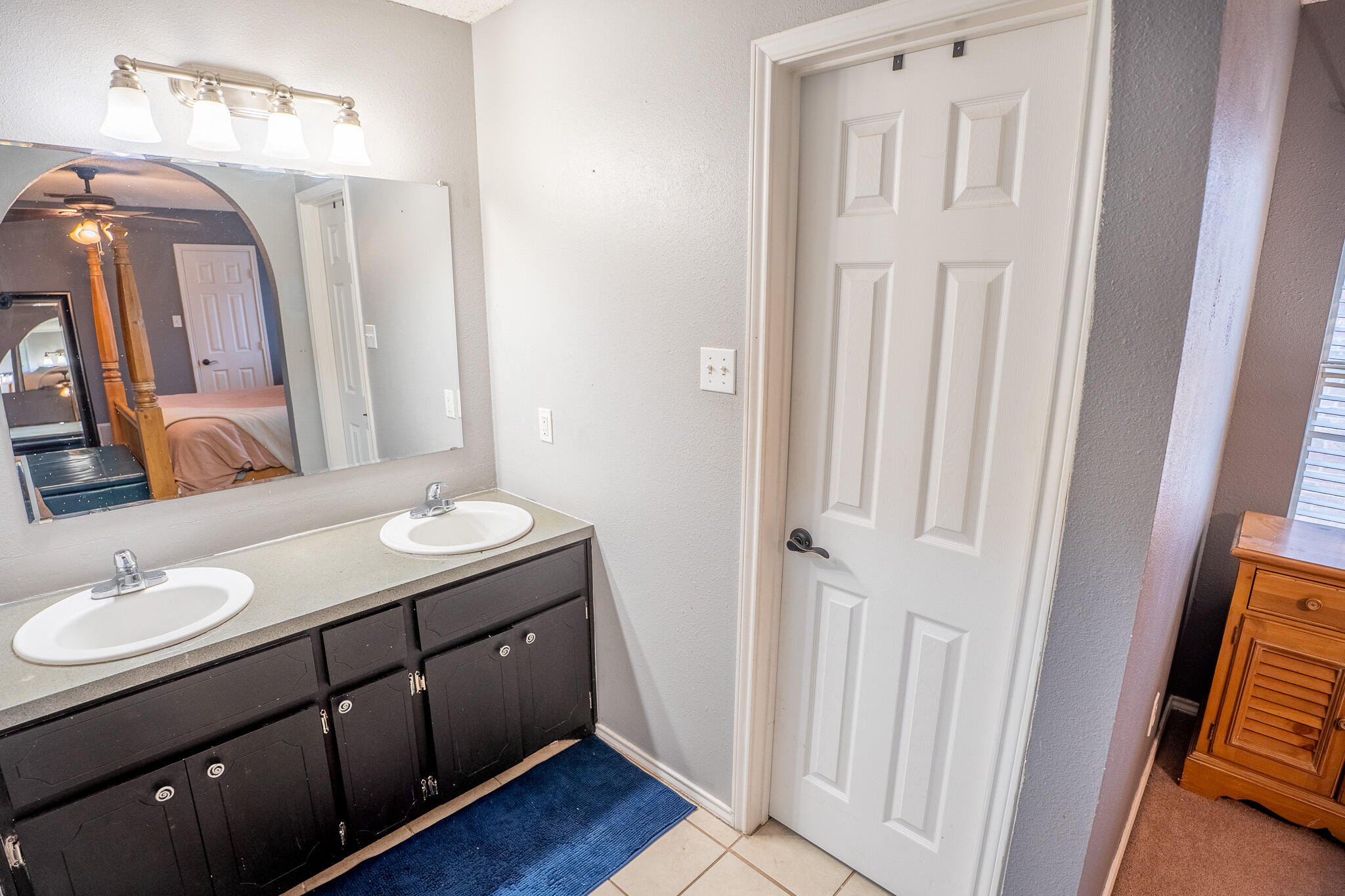 1609 78th Street Lubbock, TX 79423 - Photo 18 of 36 a bathroom with a sink a vanity and a mirror