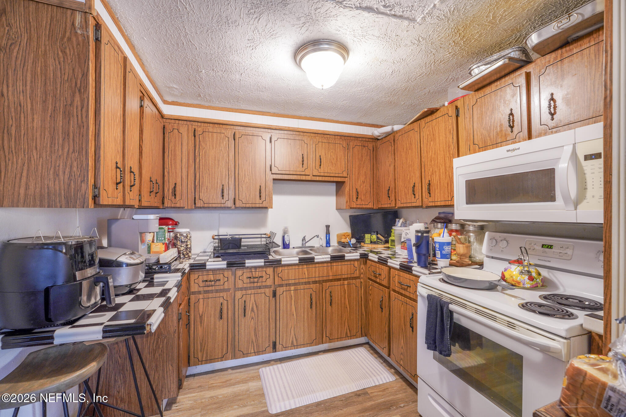 5211 Arrowsmith Road Jacksonville, FL 32208 - Photo 11 of 24 a kitchen with stainless steel appliances granite countertop a sink stove and cabinets