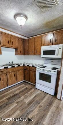 5211 Arrowsmith Road Jacksonville, FL 32208 - Photo 12 of 24 a kitchen with granite countertop a stove and cabinets