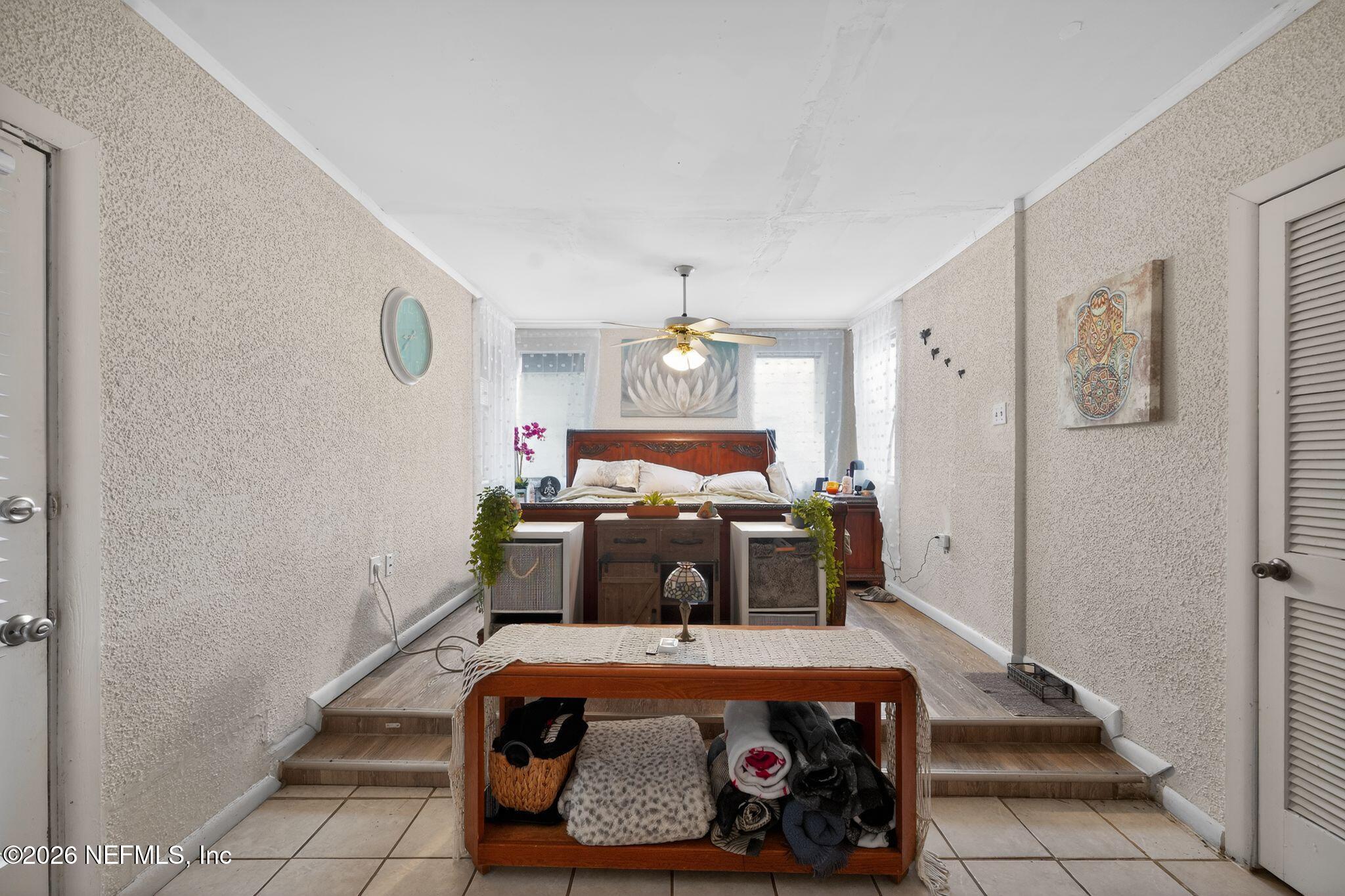 5211 Arrowsmith Road Jacksonville, FL 32208 - Photo 13 of 24 a bed room with a bed and a chandelier