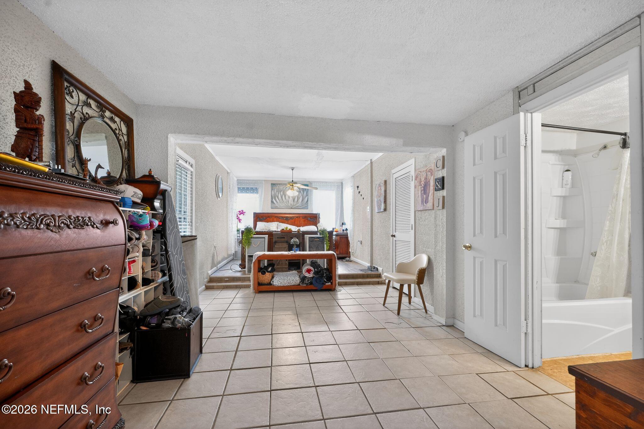 5211 Arrowsmith Road Jacksonville, FL 32208 - Photo 14 of 24 a living room with furniture and a flat tv screen