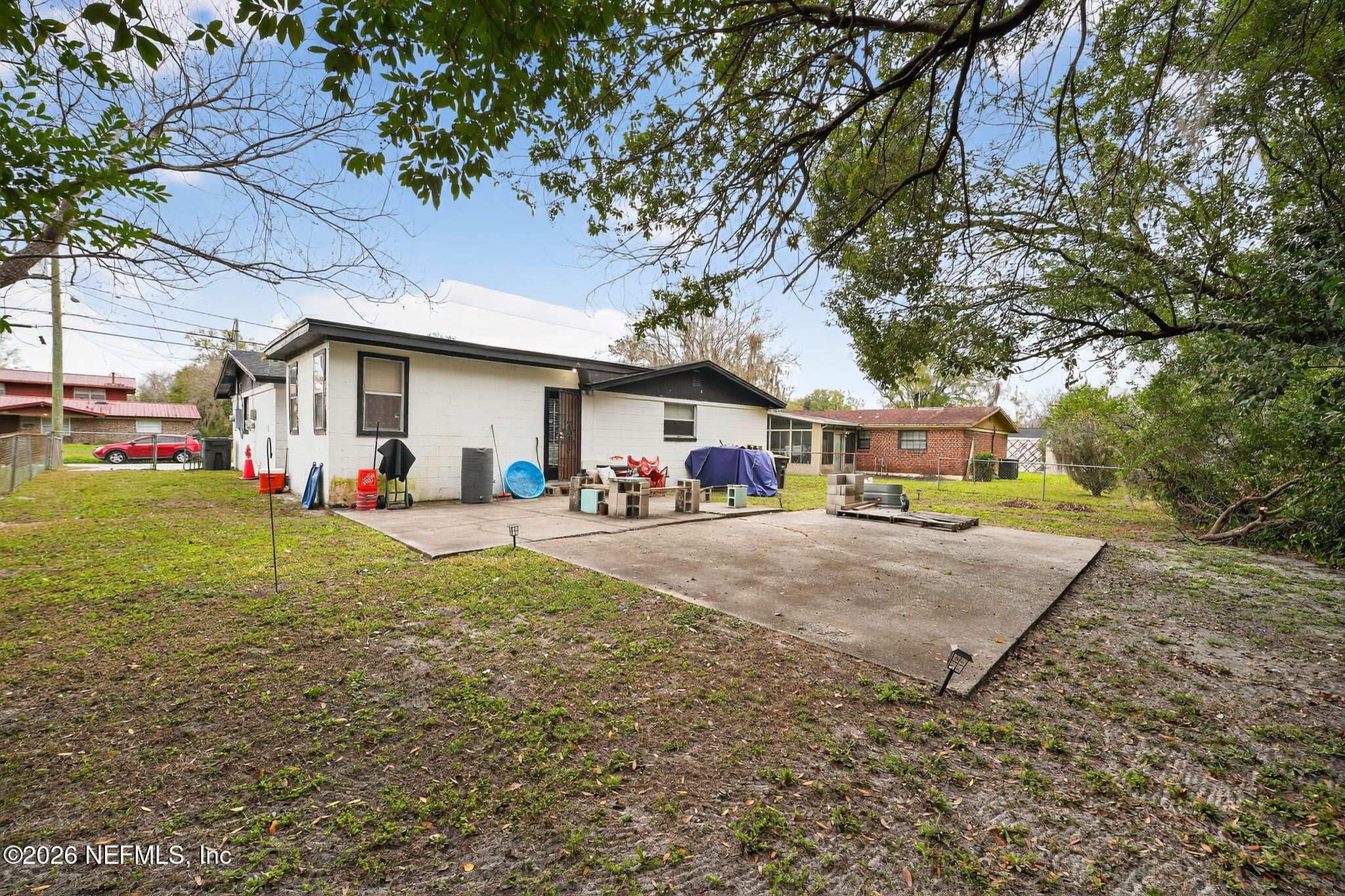 5211 Arrowsmith Road Jacksonville, FL 32208 - Photo 24 of 24 a front view of a house with a yard and table and chairs