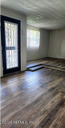 5211 Arrowsmith Road Jacksonville, FL 32208 - Photo 5 of 24 a view of an empty room with wooden floor and a window