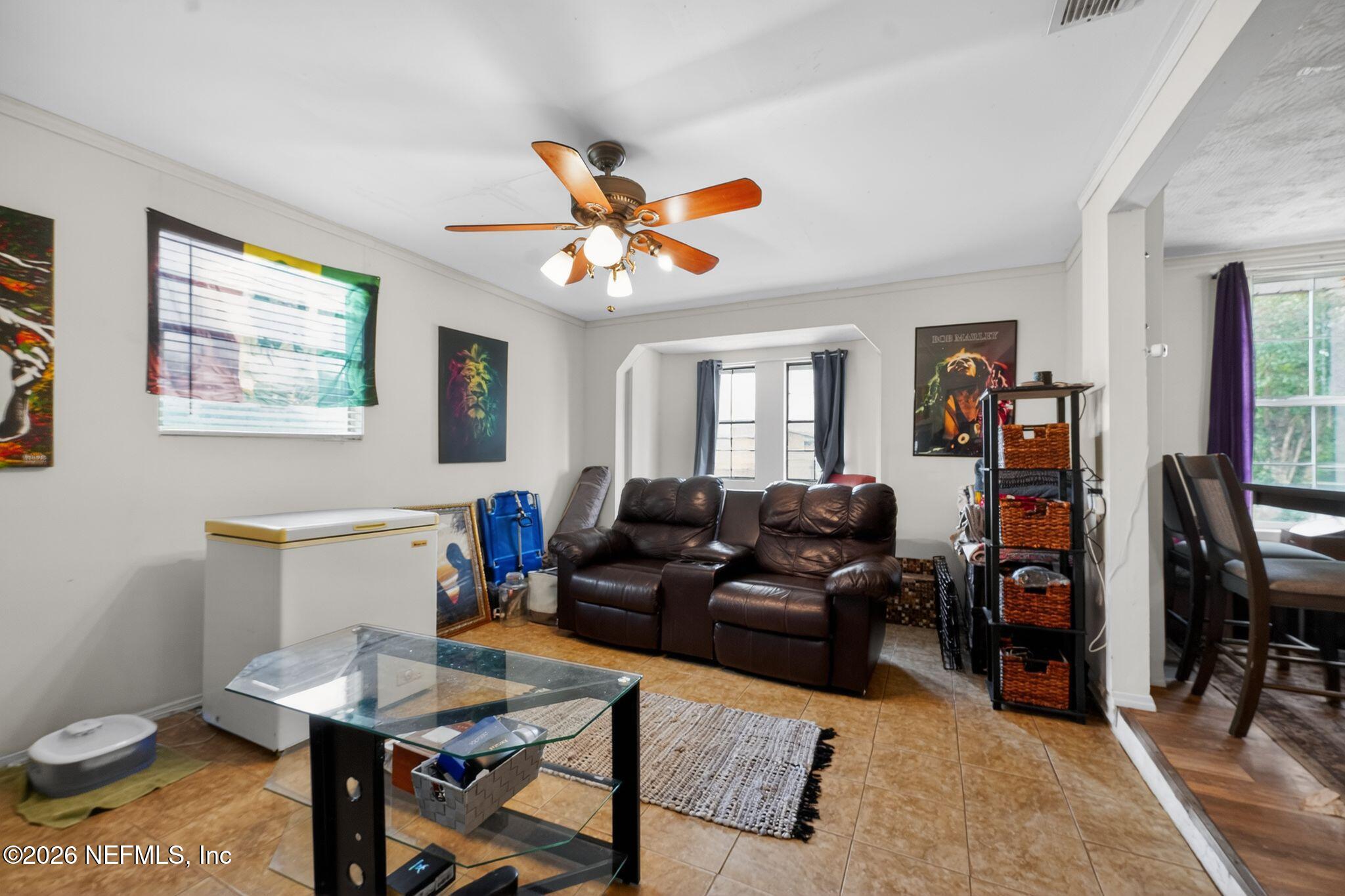5211 Arrowsmith Road Jacksonville, FL 32208 - Photo 7 of 24 a living room with furniture a rug and a window