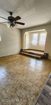 5211 Arrowsmith Road Jacksonville, FL 32208 - Photo 8 of 24 a view of empty room with wooden floor and fan