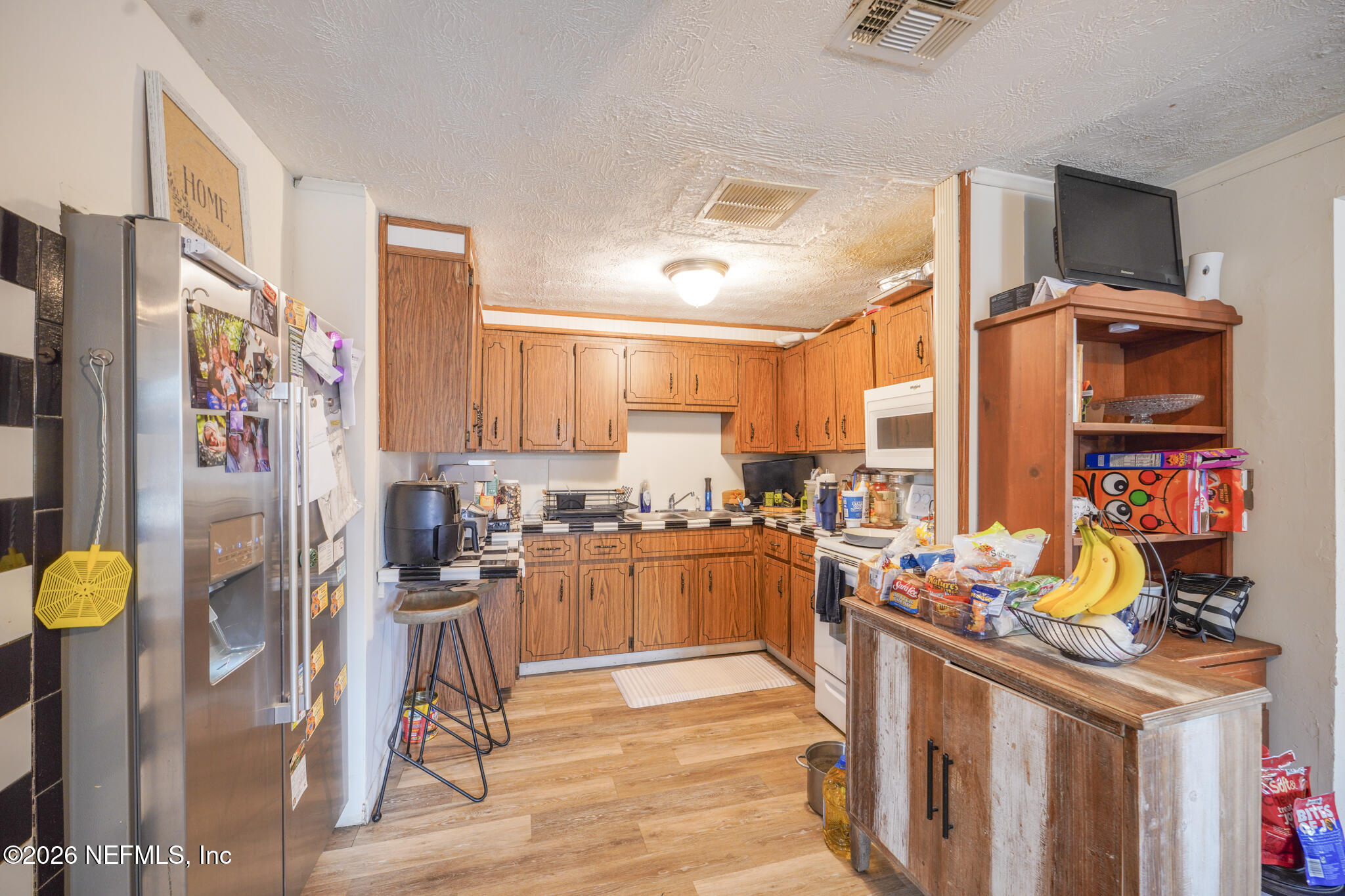 5211 Arrowsmith Road Jacksonville, FL 32208 - Photo 9 of 24 a kitchen with stainless steel appliances kitchen island granite countertop a sink and cabinets