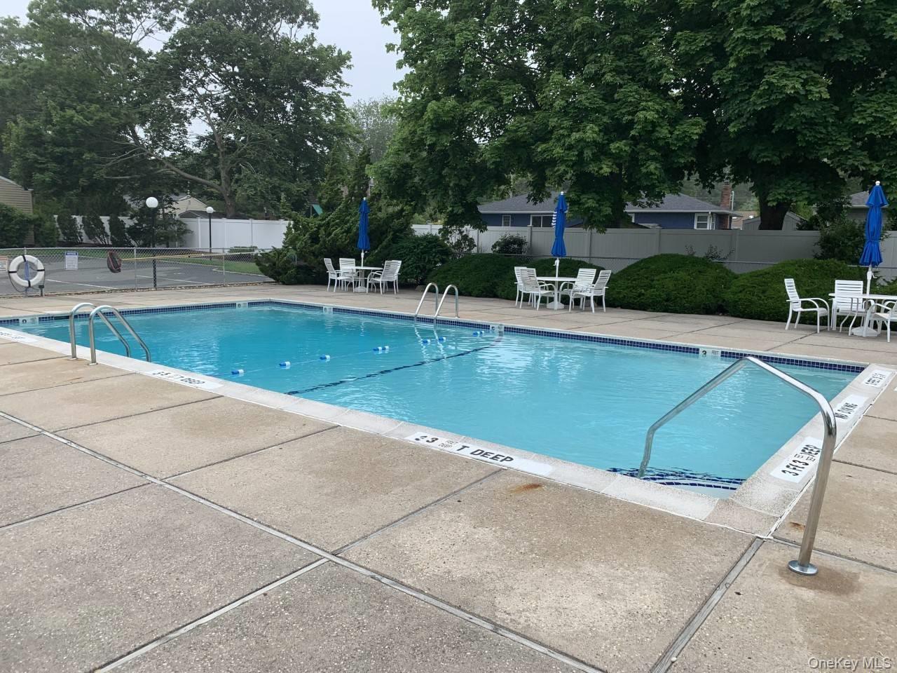 95 Springville Road, Unit 8 Hampton Bays, NY 11946 - Photo 11 of 12 a view of a swimming pool with a patio