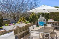 95 Springville Road, Unit 8 Hampton Bays, NY 11946 - Photo 2 of 12 a view of a patio with furniture and garden