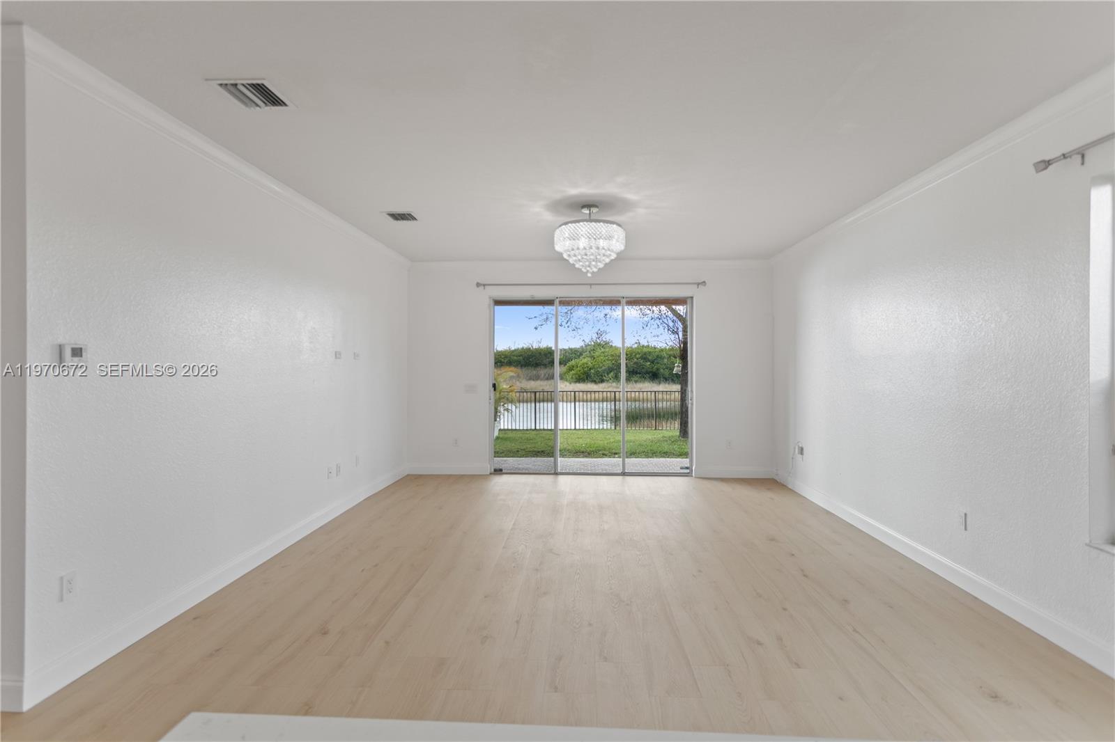 4116 Southwest 179th Way Miramar, FL 33029 - Photo 12 of 43 a view of an empty room with wooden floor and a window