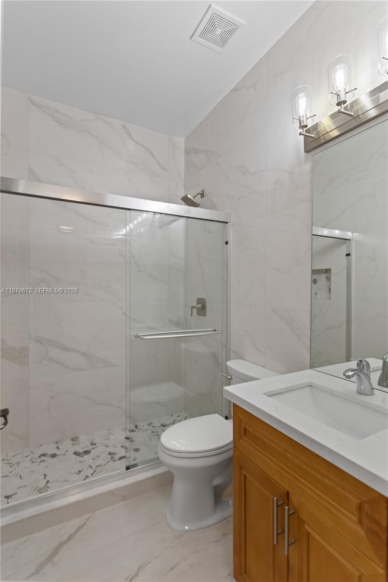 4116 Southwest 179th Way Miramar, FL 33029 - Photo 13 of 43 a bathroom with a sink a toilet and shower