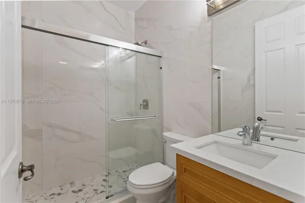 a bathroom with a sink toilet and shower